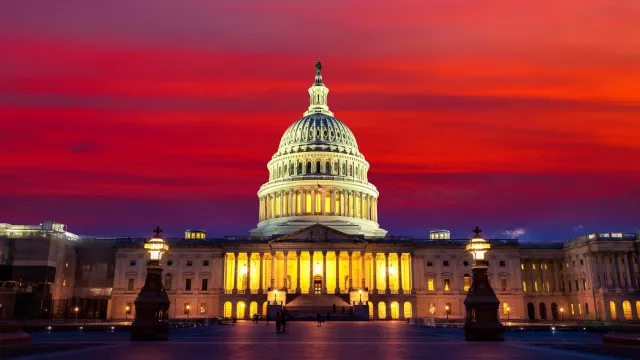 The United States Capitol building at sunset at night in Washington DC